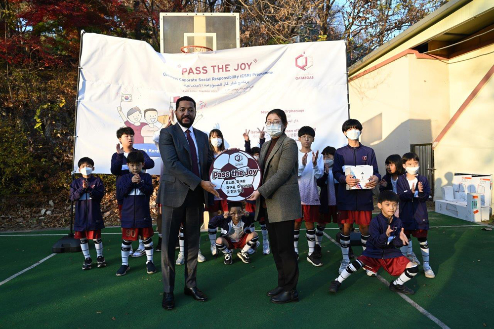 Officials from the Qatargas Korea Liaison Office present football gear to children at the Myoungryun Child Welfare Centre in Seoul as part of a 