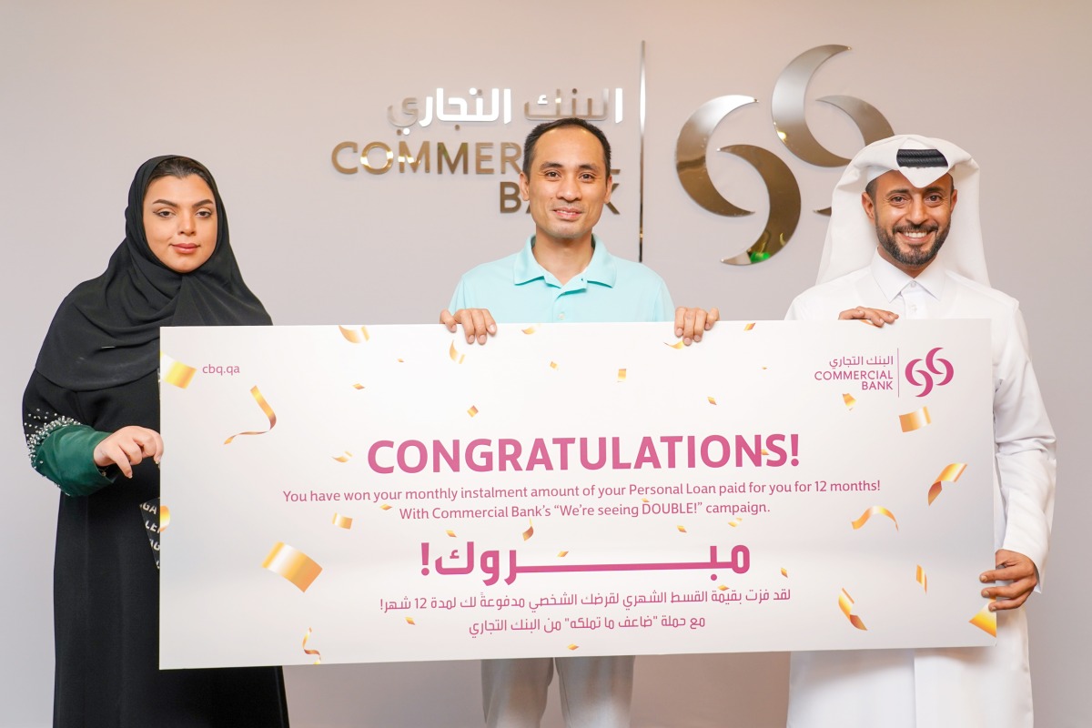 Commercial Bank officials with a winner of ‘We’re Seeing Double’ campaign.