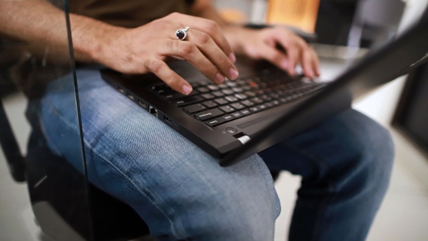 File photo: An employee works on a laptop at the headquarters of security system developer Staqu Technologies Pvt. in Gurugram, Haryana, India, on September 10, 2019. (Anindito Mukherjee/Bloomberg)