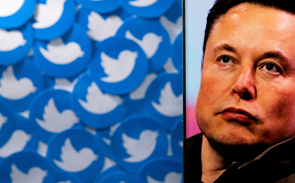 An image of Elon Musk is seen on a smartphone placed on printed Twitter logos in this picture illustration taken April 28, 2022. File Photo / Reuters