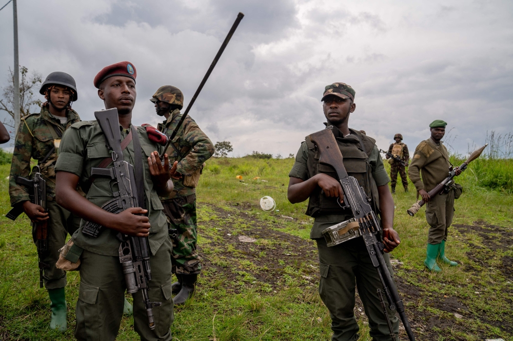 M23 rebels look on in Kibumba in eastern Democratic Republic of Congo, on December 23, 2022.  (Photo by GLODY MURHABAZI / AFP)