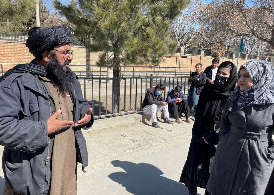 A member of Taliban speaks with female students outside the Kabul Education University in Kabul, Afghanistan, on February 26, 2022. File Photo / Reuters