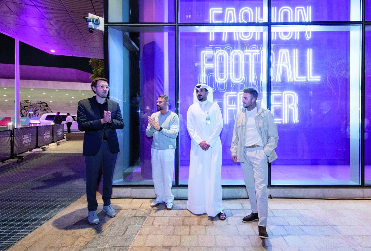Football legend David Beckham; Dean VCUarts Qatar Amir Berbić; and others view the window displays.