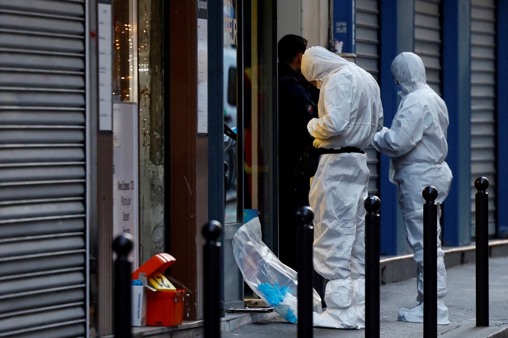 French scientific police work on Rue d'Enghien after gunshots were fired, killing and injuring several people, in a central district of Paris, France, on December 23, 2022. REUTERS/Sarah Meyssonnier/File Photo
