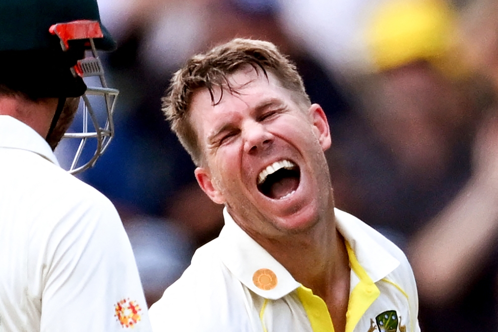 Australian batsman David Warner celebrates scoring his double century on the second day of the second cricket Test match between Australia and South Africa at the MCG in Melbourne on December 27, 2022. (Photo by William West / AFP)