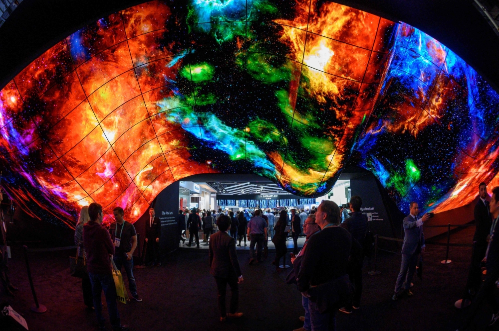 In this file photo taken on January 10, 2020 attendees experience the LG OLED Wave made up of 200 55-inch LG OLED digital screens on the final day of the 2020 Consumer Electronics Show (CES) in Las Vegas, Nevada. Photo by Robyn Beck / AFP