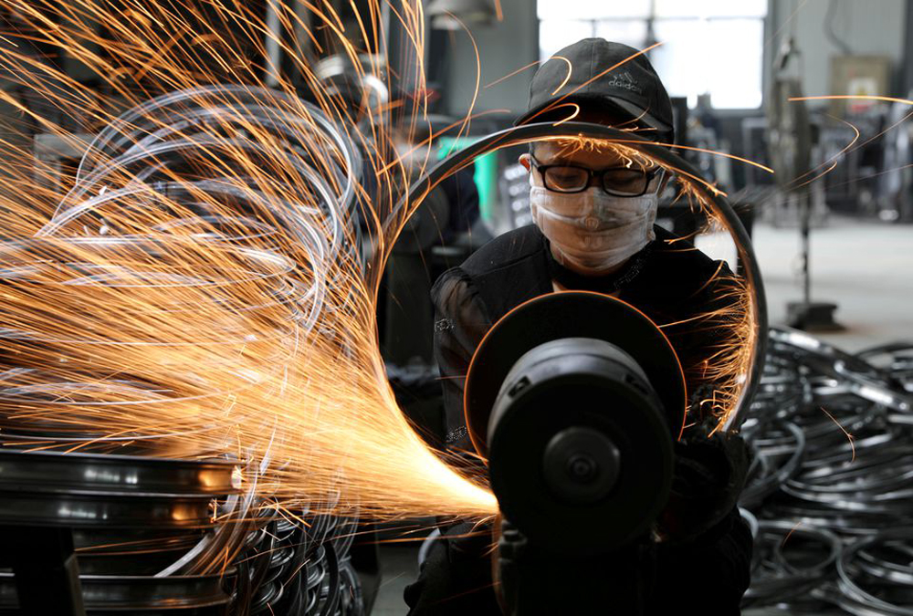 A worker polishes a bicycle steel rim at a factory manufacturing sports equipment in Hangzhou, Zhejiang province, China. (REUTERS)