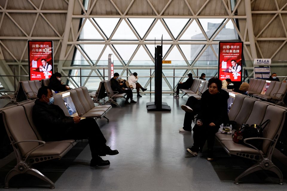 Travellers wait to board their plane at Chengdu Shuangliu International Airport amid a wave of the coronavirus disease (COVID-19) infections, in Chengdu, Sichuan province, China December 30, 2022. REUTERS/Tingshu Wang
