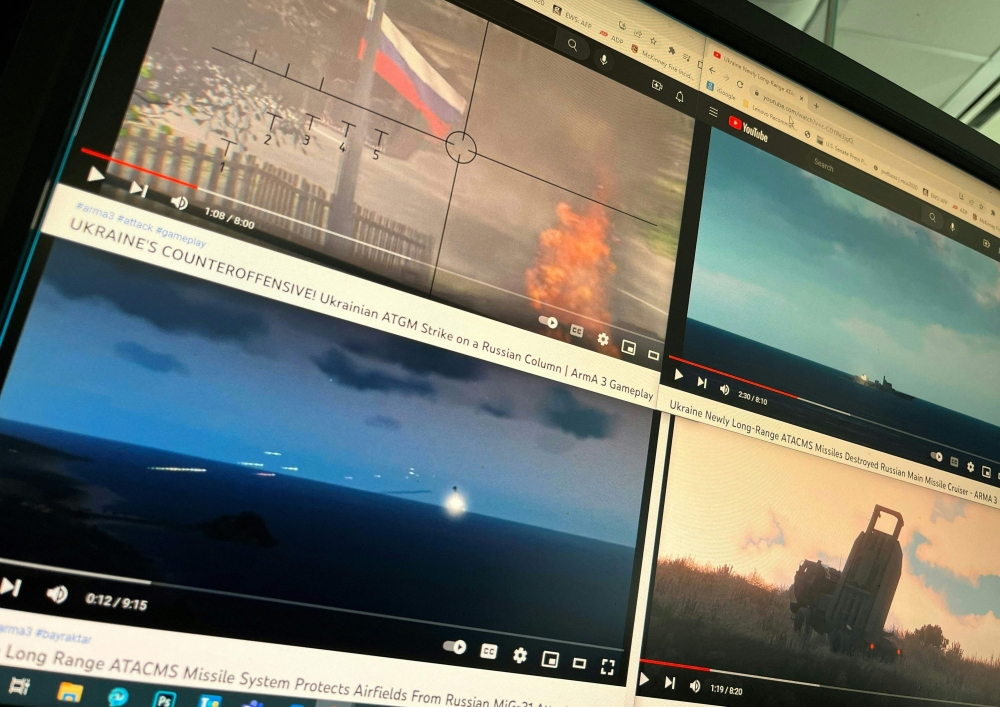 Photo illustration generated in an office in Washington, DC on December 28, 2022, shows a computer screen with four YouTube windows displaying combat clips from Arma 3's war-themed video games. AFP