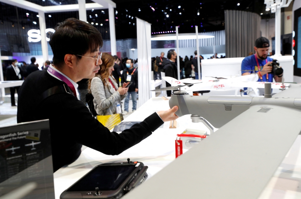 An attendee looks over a Dragonfish drone at the Auto Robotics booth during CES 2023, an annual consumer electronics trade show, in Las Vegas, Nevada, U.S. January 5, 2023. REUTERS/Steve Marcus