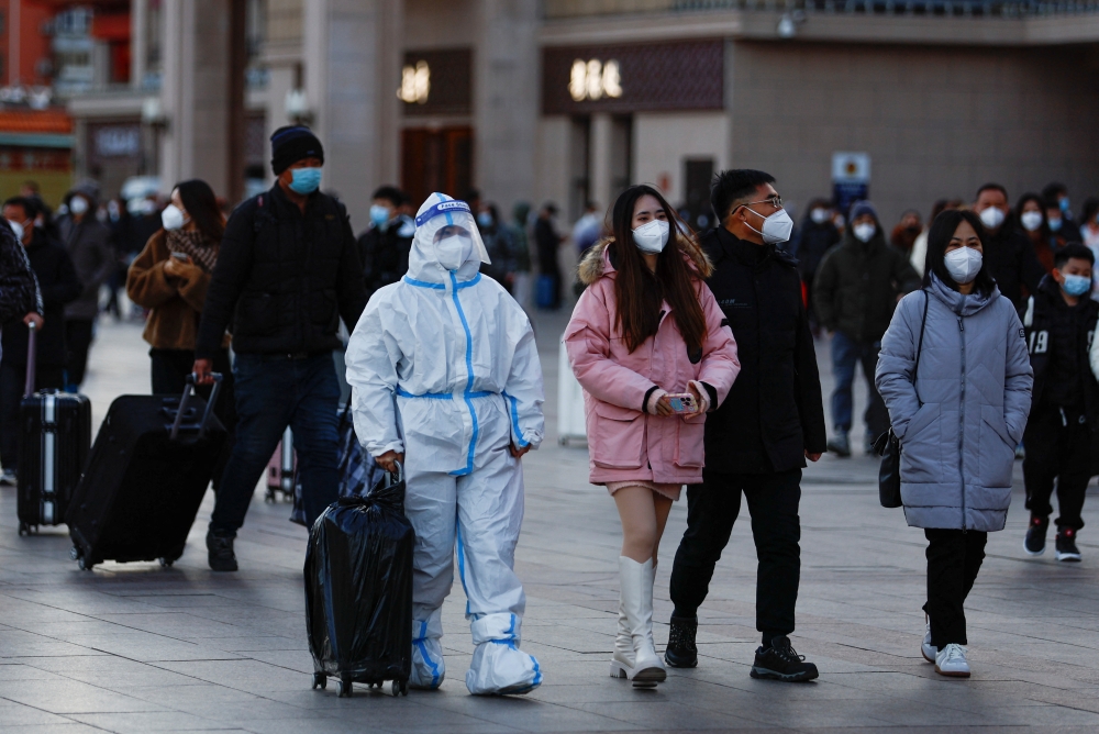People arrive to Shanghai Hongqiao International Airport, in Shanghai on January 7, 2023. (Photo by Hector RETAMAL / AFP)