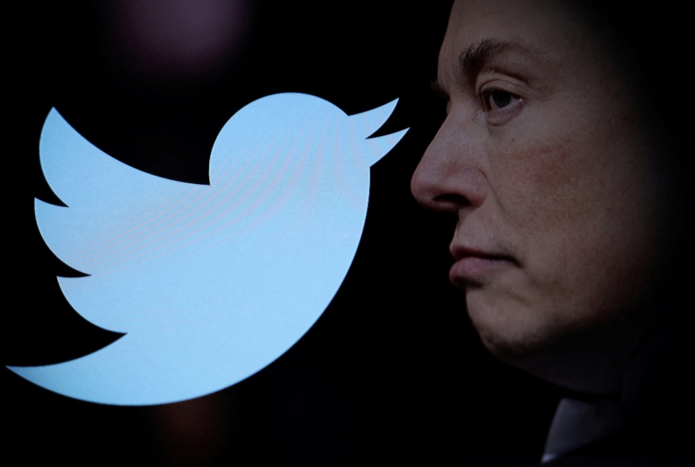 Twitter logo and a photo of Elon Musk are displayed through magnifier in this illustration taken on October 27, 2022. File Photo / Reuters