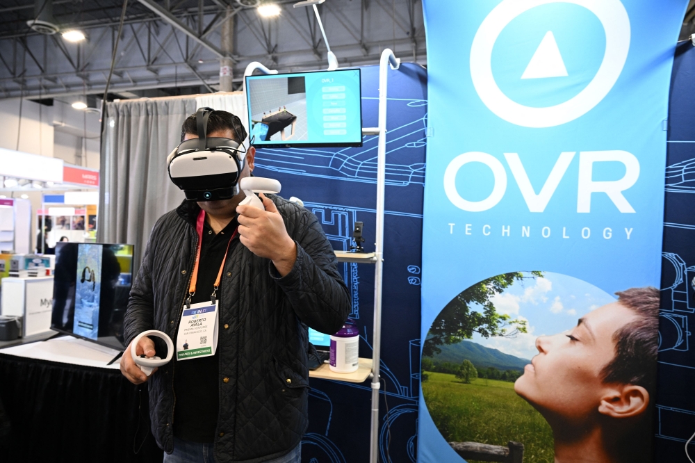 An attendee tries OVR Technology's ION 3 during the Consumer Electronics Show (CES) in Las Vegas, Nevada, on January 6, 2023. (Photo by Robyn Beck/ AFP)