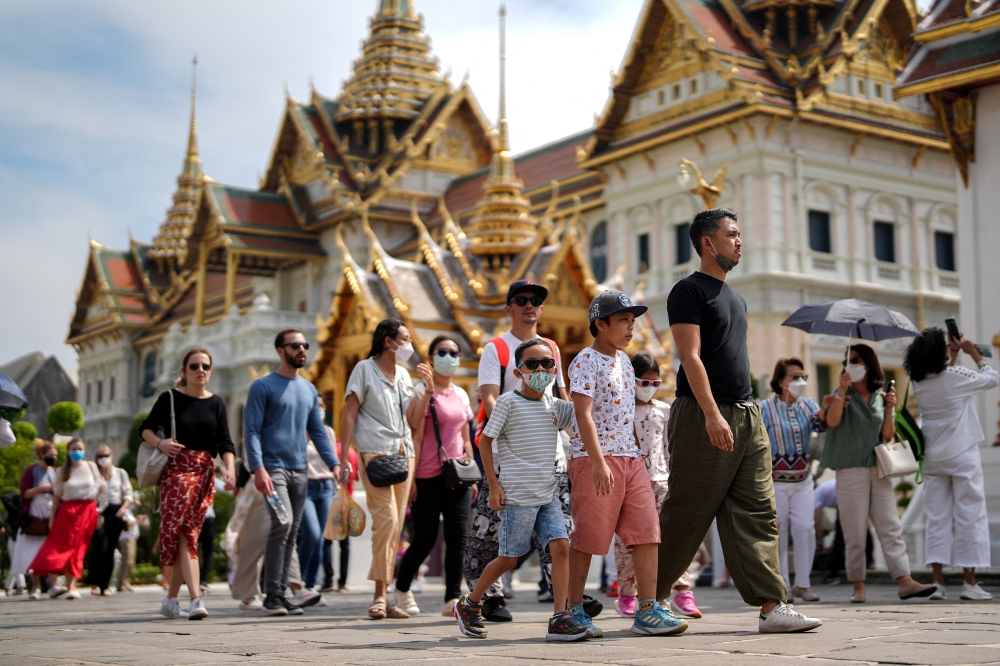 Tourists visit the Grand Palace, one of the top tourist attraction spots as Thailand is expecting arrivals of Chinese tourists after China reopens its borders amid the coronavirus (COVID-19) pandemic, in Bangkok, Thailand, January 7, 2023. REUTERS/Athit Perawongmetha