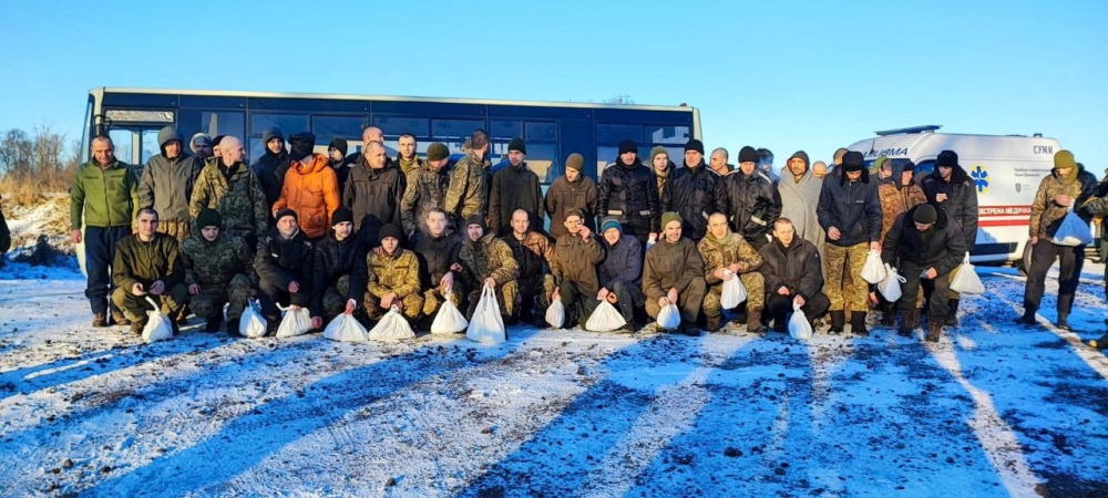 Ukrainian troops gather for a photo after being released in prisoner swap with Russia, in an unknown location in Ukraine in this handout image released January 8, 2023. (Andriy Yermak Via Telegram/Handout via REUTERS)