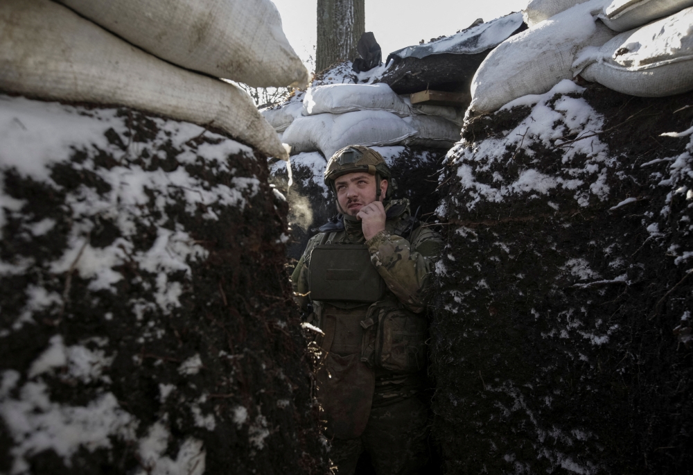 A Ukrainian serviceman stands in a trench at a frontline, amid Russia's attack on Ukraine, in Donetsk region, Ukraine January 7, 2023. Reuters/Anna Kudriavtseva