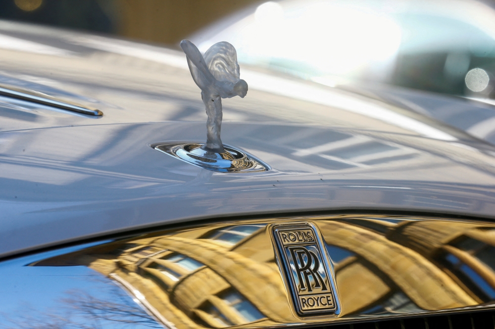 The mascot, the so-called 'Spirit of Ecstasy' or 'Emily', and the company logo are seen on the bonnet of a Rolls-Royce car in Zurich, Switzerland March 30, 2021. REUTERS/Arnd Wiegmann/File Photo