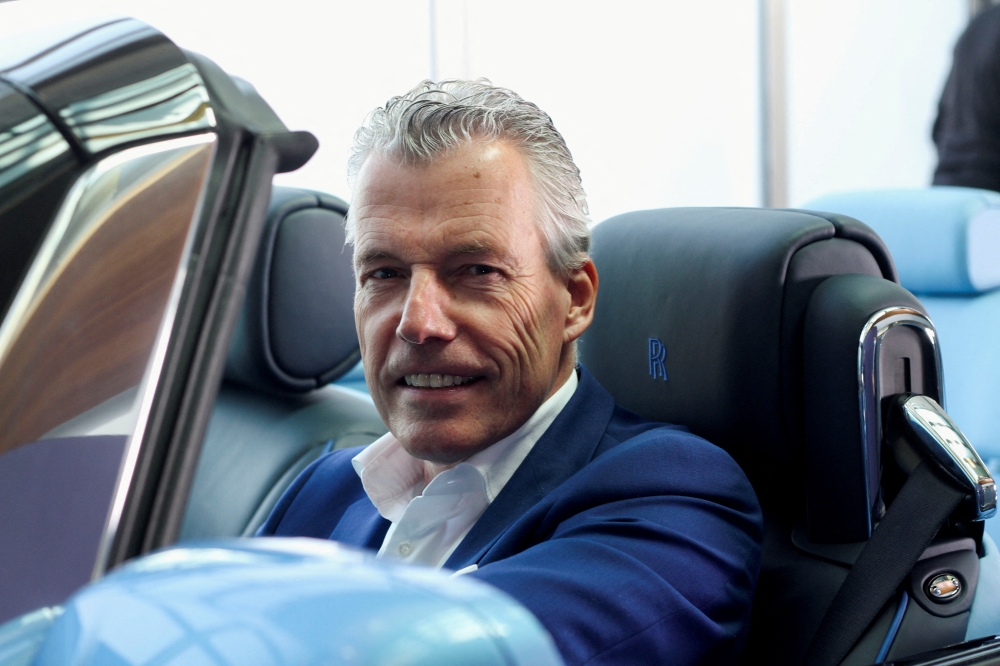 Torsten Muller-Otvos, CEO of Rolls-Royce, poses at a hand made car described as 'the most refined picnic facility on earth', at the company's factory in Goodwood, Britain May 27, 2021. (REUTERS/Stuart McDill)