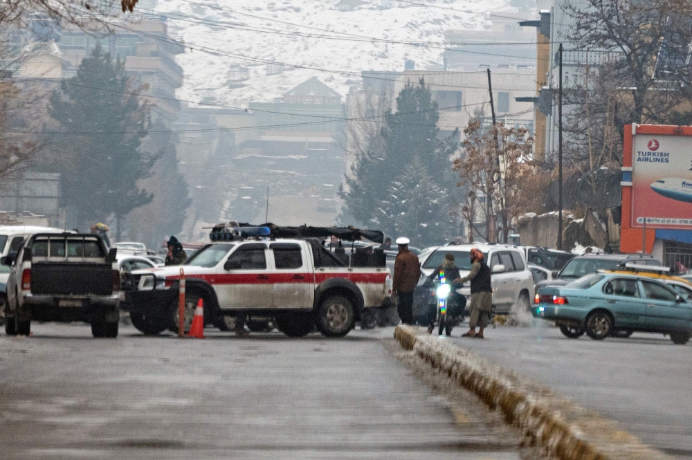 Taliban security forces block a road after a suicide blast near Afghanistan's foreign ministry at the Zanbaq Square in Kabul on January 11, 2023. (Photo by Wakil Kohsar / AFP)