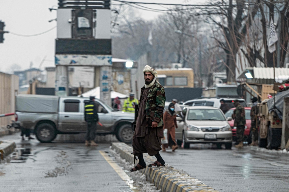 A member of Taliban security force stands guard on a blocked road after a suicide blast near Afghanistan's foreign ministry at the Zanbaq Square in Kabul on January 11, 2023. (Photo by Wakil Kohsar / AFP)