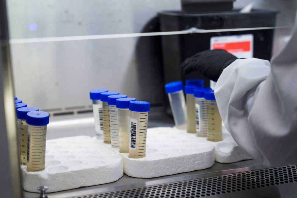 A lab technician tests wastewater samples from around the United States for the coronavirus disease (Covid-19) at the Biobot Analytics, in Cambridge, Massachusetts, US, February 22, 2022. (REUTERS/Allison Dinner)