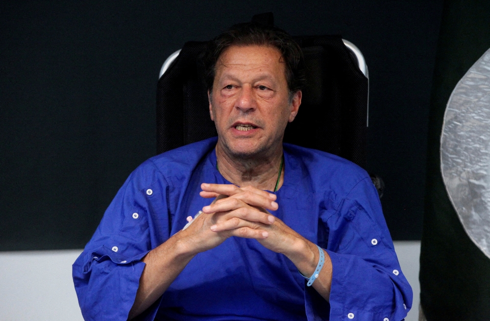 File Photo: Former Pakistan's Prime Minister Imran Khan addresses a news conference after he was wounded following a shooting incident during a long march in Wazirabad, at the Shaukat Khanum Memorial Cancer Hospital & Research Centre in Lahore, Pakistan, November 4, 2022. (REUTERS/Mohsin Raza)