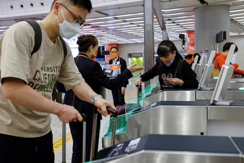 Passengers arrive at West Kowloon High-Speed Train Station Terminus on the first day of the resumption of rail service to mainland China, during the coronavirus disease (COVID-19) pandemic in Hong Kong, China, January 15, 2023. (REUTERS/Tyrone Siu)