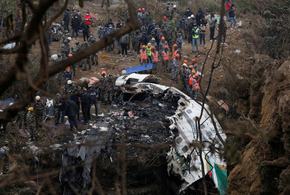 A rescue team works to recover the body of a victim from the site of the plane crash of a Yeti Airlines operated aircraft, in Pokhara, Nepal January 16, 2023. Reuters/Rohit Giri