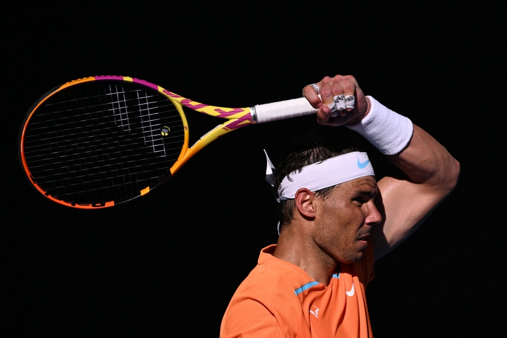 Spain's Rafael Nadal returns to Britain's Jack Draper during their men's singles match on day one of the Australian Open tennis tournament in Melbourne on January 16, 2023. (Photo by WILLIAM WEST / AFP) 