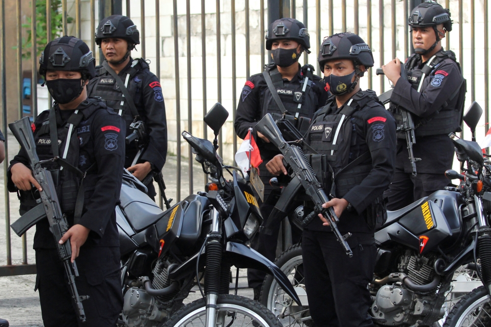 Mobile brigade police personnel stand guard outside the Surabaya court ahead of the first trial over a soccer stampede in East Java that killed 135 people in October 2022, in Surabaya, East Java province, Indonesia, January 16, 2023, in this photo taken by Antara Foto. Antara Foto/Didik Suhartono/via REUTERS 