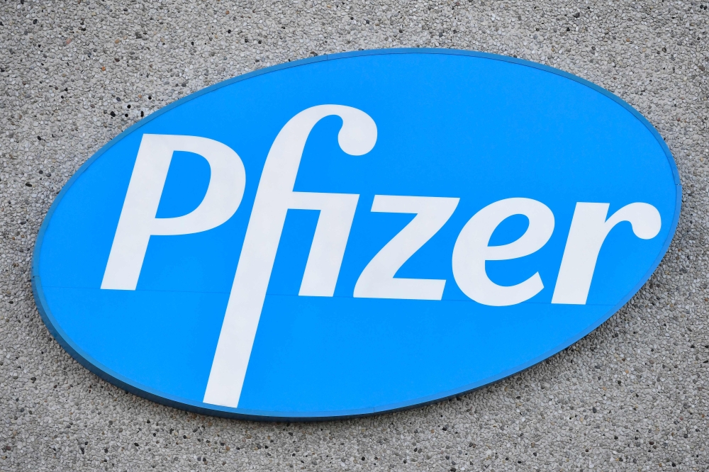 In this file photo taken on December 22, 2020 in Puurs, Begium, the logo of US multinational pharmaceutical company Pfizer at the production site of the Covid-19 vaccine that was given the European Union's green light the day before, paving the way for vaccinations to finally start in the 27-nation block. (Photo by JOHN THYS / AFP)