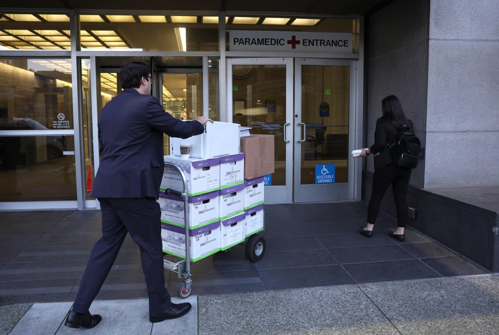 Legal aides move boxes of material as they arrive for the Elon Musk shareholder lawsuit trial at the Phillip Burton Federal Building on January 17, 2023 in San Francisco, California. Justin Sullivan/Getty Images/AFP