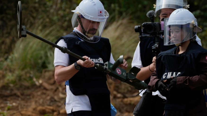  Ukrainian deminer, left, holds a mine detector as he listens to a Cambodia Mine Action Center, CMAC, demining expert, right, during a training session in Preytotoeung village, Battambang province, Cambodia, Thursday, Jan 19, 2023. Cambodian experts, whose country has the dubious distinction of being one of the world’s most contaminated by landmines, walked a group of Ukrainian soldiers through a minefield being actively cleared Thursday, hoping their decades of experience will help the Europeans in their own efforts to remove Russian mines at home. (AP Photo/Heng Sinith)