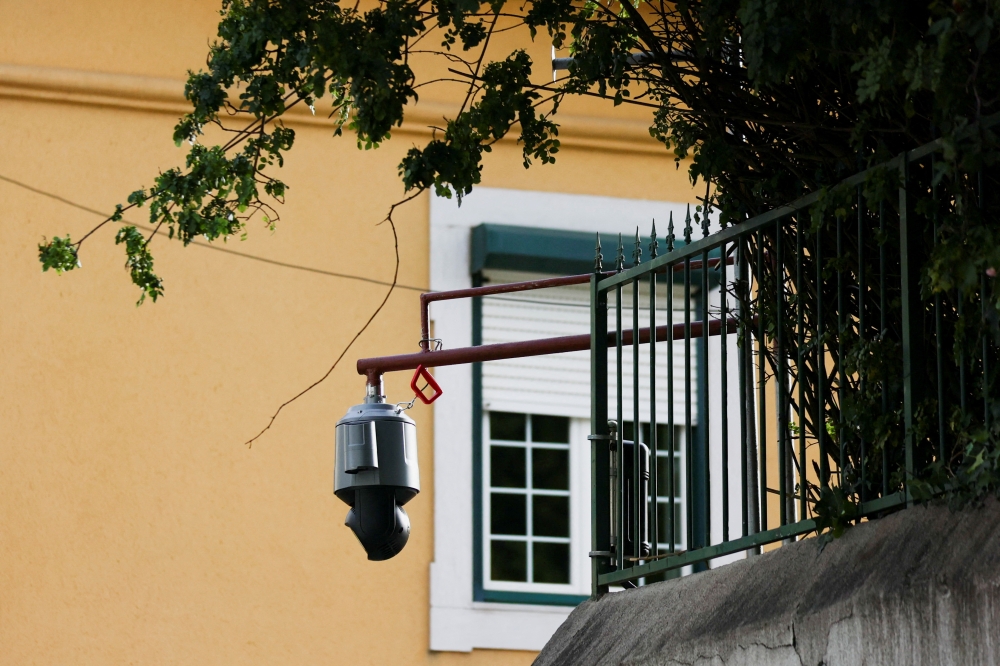 A surveillance camera is seen pointed to the exterior of the Chinese embassy in Lisbon, Portugal, December 21, 2022. (REUTERS/Pedro Nunes)

