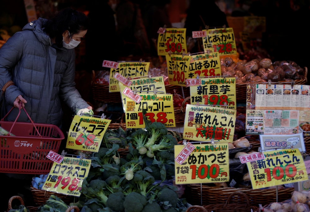 A shopper checks food items at a supermarket in Tokyo, Japan January 20, 2023. REUTERS/Issei Kato