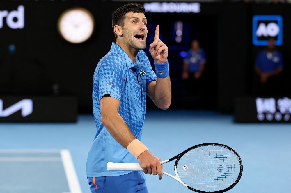 Serbia's Novak Djokovic reacts as he competes against Bulgaria's Grigor Dimitrov during their men's singles match on day six of the Australian Open tennis tournament in Melbourne on January 21, 2023. (Photo by Martin KEEP / AFP)