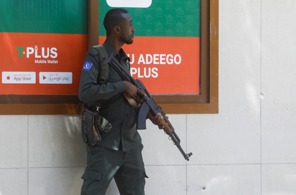 A Somali policeman stands holds his position near the mayor's office following a blast in Mogadishu, Somalia January 22, 2023. REUTERS/Feisal Omar