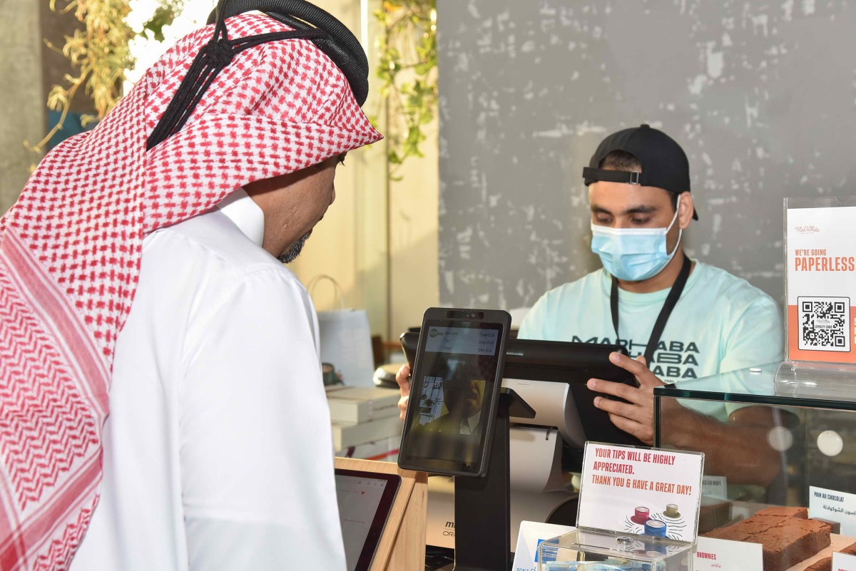 An official of the QNB Group launches the facial payments solution.