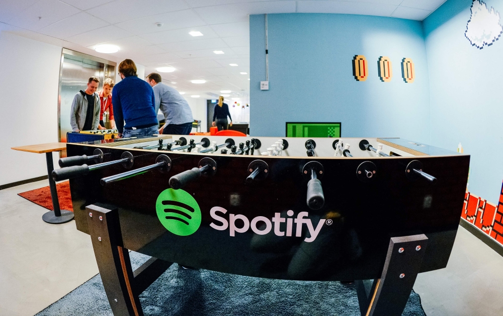In this file photo taken on February 18, 2015, the Spotify logo is pictured on a football table placed in a playroom at the company headquarters in Stockholm. (Photo by Jonathan Nackstrand / AFP)