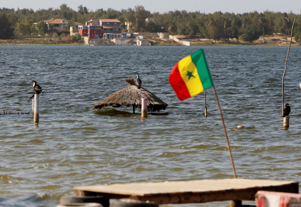 A general view of the submerged tourism businesses at the Pink Lake (Lac Rose), officially known as Lake Retba, after extreme floods washed away salt mounts and contaminated the lake and turned its famous waters from pink to green, in Niaga, near Dakar, Senegal, January 17, 2023. REUTERS/ Zohra Bensemra