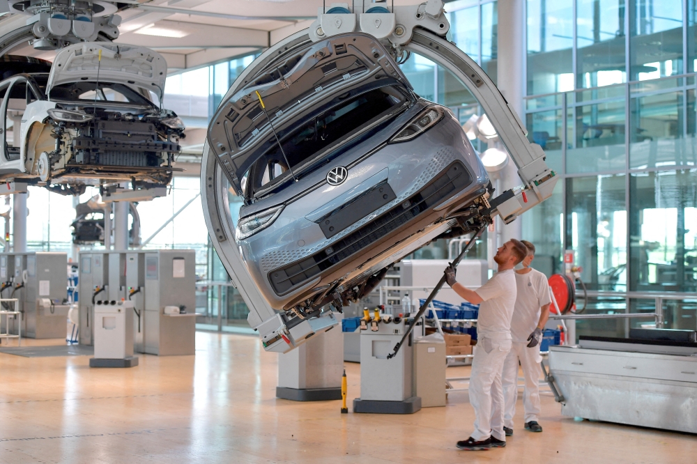 FTechnicians work on the assembly line of German carmaker Volkswagen's electric ID. 3 car in Dresden, Germany, June 8, 2021. File Photo:  REUTERS/Matthias Rietschel/File Photo
