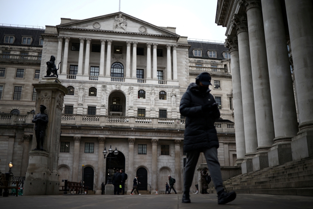 People walk outside the Bank of England in the City of London financial district, in London, Britain, January 26, 2023. REUTERS/Henry Nicholls