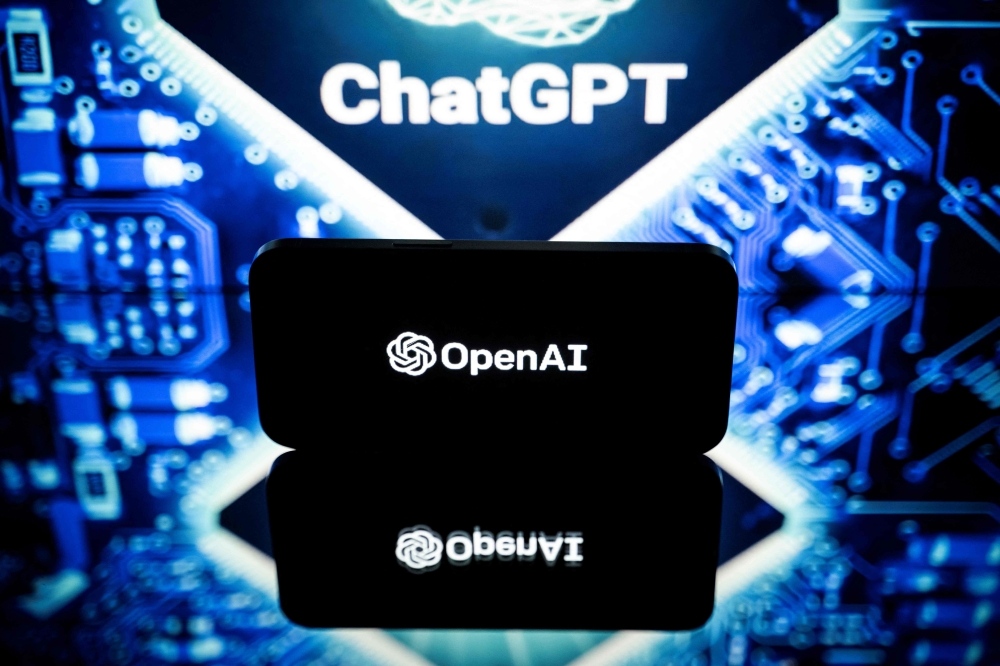 This picture taken on January 23, 2023 in Toulouse, southwestern France, shows screens displaying the logos of OpenAI and ChatGPT. ChatGPT is a conversational artificial intelligence software application developed by OpenAI. (Photo by Lionel Bonaventure / AFP)