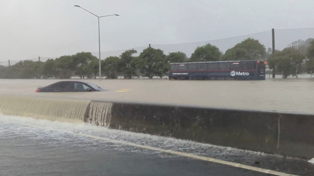 Stranded vehicles are seen during heavy rainfall in Auckland, New Zealand January 27, 2023, in this screen grab obtained from a social media video. @MonteChristoNZ/via Reuters