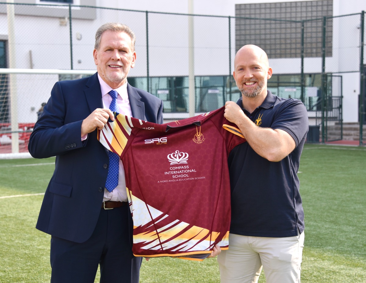 Officials with a rugby jersey.