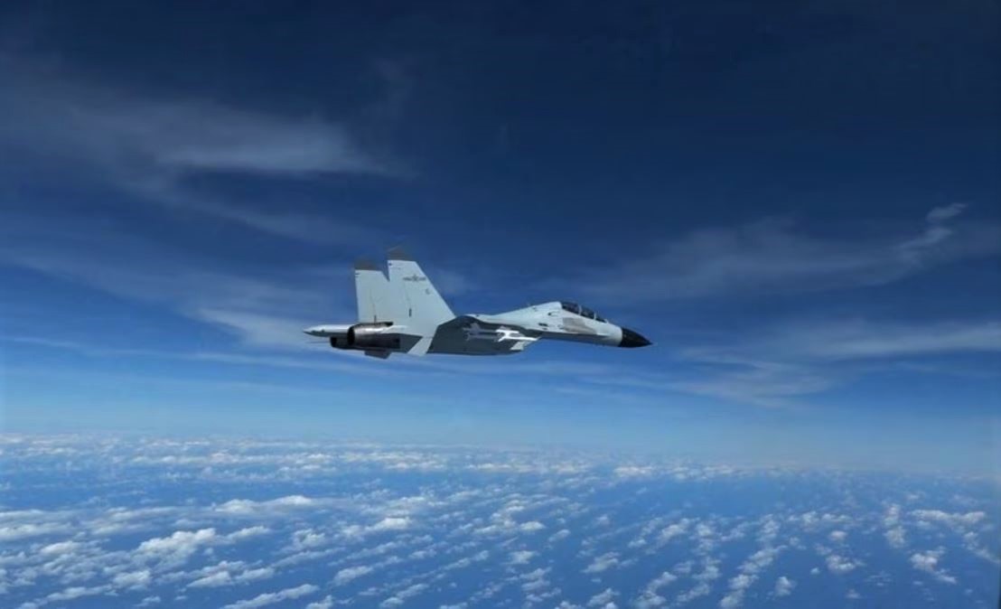 A Chinese Navy J-11 fighter jet is recorded flying close to a US Air Force RC-135 aircraft in international airspace over the South China Sea, according to the US military, in a still image from video taken December 21, 2022. (US Indo-Pacific Command/Handout via REUTERS)