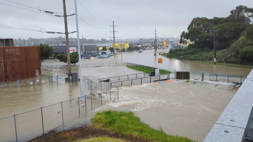 An area flooded during heavy rainfall is seen in Auckland, New Zealand January 27, 2023, in this screen grab obtained from a social media video. @MonteChristoNZ/via REUTERS