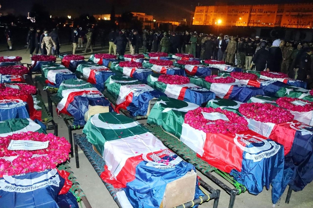 This handout picture taken on January 30, 2023 and released by the Pakistan's Police Department shows Pakistan's security officials gather to attend funeral prayers for police officers who were killed in a mosque blast inside the police headquarters in Peshawar. - Police were among 61 people killed and 150 wounded in a blast at a mosque inside a highly sensitive Pakistan police headquarters on January 30, prompting the government to put the country on high alert. (Photo by Handout / Pakistan's Police Department / AFP)