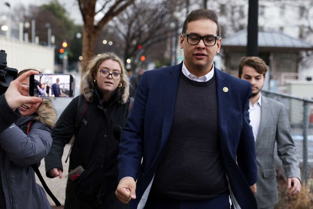US Rep. George Santos leaves the Capitol Hill Club as members of the press follow him on January 31, 2023 in Washington, DC. Amid ongoing investigations into his finances, campaign spending and false statements on the campaign trail, Santos is reportedly recusing himself from his House committee assignments. Alex Wong/Getty Images/AFP