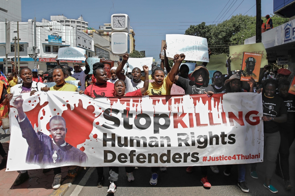 Members of various Human Rights Defender (HRD) groups hold a protest against the brutal killing of renowned human rights lawyer, Thulani Maseko at his home in the kingdom of eSwatini (formerly known as Swaziland) in the Kenyan capital, Nairobi on January 30, 2023. (Photo by Tony KARUMBA / AFP)